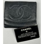 A CHANEL BLACK 'CAVIAR' LEATHER BI-FOLD PURSE WALLET, stamped within 'Made in Italy' and 'Chanel'.