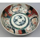 A JAPANESE PORCELAIN BOWL, decorated with imagery of cranes and blossom trees in the Imari palette.