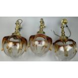 A SET OF THREE COLOURED GLASS 1970'S HANGING CEILING LIGHTS, with brass drops. 40cm x 22cm