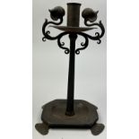 IN THE MANNER OF LIBERTY AND CO, an arts and crafts wrought iron candle stick.