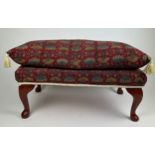 A FOOTSTOOL UPHOLSTERED IN WILLIAM MORRIS STYLE FABRIC WITH FRINGE TASSLED CUSHION