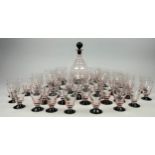 AN ART DECO STYLE ROSE GLASS DECANTER AND GLASSES, consisting of one large decanter, 12 large, 11