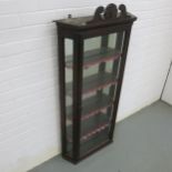 A VICTORIAN GLAZED DISPLAY CABINET, mirrored back with four shelves and crested pediment. 132cm x