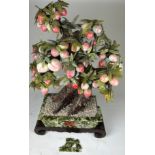 A CHINESE TREE MADE FROM CERAMIC / RESIN BEARING FRUITS WITH FAUX JADE LEAVES, raised in a faux