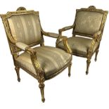 A MATCHED PAIR OF LARGE FRENCH FAUTEUILS, gilt painted with similarly upholstered overstuffed seats.