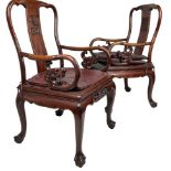A PAIR OF CHINESE HARDWOOD ARMCHAIRS, with carved dragon head arms on four legs terminating in