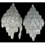 A PAIR OF DESIGNER GLASS WALL LIGHTS ON WHITE METAL FRAMES,