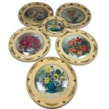 A COLLECTION OF SIX OIL ON PANEL PAINTINGS OF FLOWERS, in Regency style circular wall mirror frames.