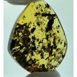 A VERY FINE AMBER CABOCHON CONTAINING MULTIPLE INSECTS AND A PAIR OF RED LEAVES, From Chiapas,