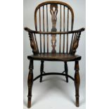 AN OAK WINDSOR ARMCHAIR, with pierced central splat and spindle back raised on four legs