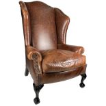 A GEORGE SMITH BROWN LEATHER WINGBACK ARMCHAIR