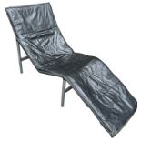 A DANISH LOUNGER BY HJALMAR LYSTAGER, black leather raised on a metal base. 160cm x 90cm