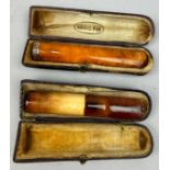 TWO AMBER CIGAR PIPES, in cases