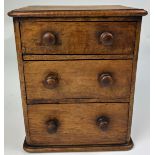 A MINIATURE APPRENTICE'S MAHOGANY CHEST OF DRAWERS, with three graduated drawers.