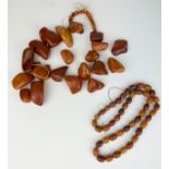 A LARGE BALTIC AMBER BUTTERSCOTCH NECKLACE ALONG WITH A SMALLER EXAMPLE