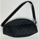 A SMALL GUCCI HANDBAG IN BLACK, with interlocking 'GG' monogram throughout and inner zipped