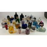 A COLLECTION OF PARTIALLY USED DESIGNER PERFUME BOTTLES, to include Dior, Calvin Klein and more