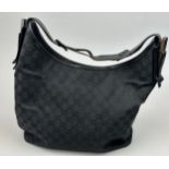 A GUCCI SHOULDER BAG, black with central zipped compartment and interlocking 'GG' emblem throughout.