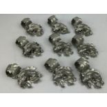 A SET OF NINE SILVER PLATED NAPKIN RINGS REALISTICALLY FIGURED IN THE FORM OF HOGS ON LEAVES, in the