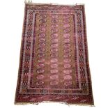 A PERSIAN RUG, Faded and damaged 185cm x 115cm