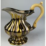 A SILVER PLATED AND GILT JUG WITH BONE HANDLE 12cm in height