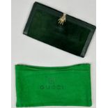 A VINTAGE GUCCI PURSE WITH HAND CLIP, green suede with dustbag