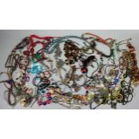 A LARGE QUANTITY OF COSTUME JEWELLERY, to include mother of pearl, beaded necklaces and more (Qty)