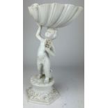 A LARGE ITALIAN BLANC DE CHINE PORCELAIN FIGURE OF A PUTTI HOLDING A SCALLOP SHELL Various damages