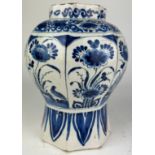 A DUTCH DELFT VASE BLUE AND WHITE PAINTED WITH FLOWERS, octagonal shape probably 18th century.