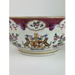A CHINESE EXPORT 'ARMORIAL' FAMILLE ROSE PUNCH BOWL, Painted with a coat of arms, and foliate