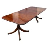 A TWIN PEDESTAL MAHOGANY DINING TABLE PROBABLY BY WILLIAM TILLMAN, two removable leaves, along