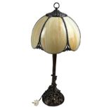 IN THE MANNER OF TIFFANY STUDIOS (1899-1930), faux bronze table lamp naturalistically figured with