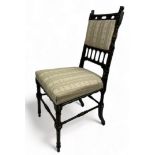 AN AESTHETIC MOVEMENT EBONISED SIDE CHAIR OF GOTHIC DESIGN, with pierced back rail of shaped