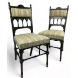A PAIR OF AESTHETIC MOVEMENT EBONISED SIDE CHAIRS OF GOTHIC DESIGN, with pierced back rail of shaped