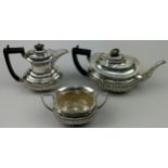 A MATCHED SILVER TEA SET, comprising two tea pots and a sugar bowl, each having a gadrooned edge.