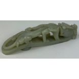 A CHINESE JADE BELT BUCKLE DEPICTING A FOUR LEGGED CREATURE, probably 19th Century