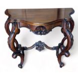 A REPRODUCTION MAHOGANY CONSOLE TABLE IN THE ROCOCCO STYLE, ornately carved with S scrolls and C