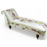 A VICTORIAN CHAISE LOUNGE UPHOLSTERED IN CONTEMPORARY FABRIC OF FOLIATE DESIGN, raised on baluster