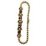 AN 18CT GOLD LADIES FLOWER BRACELET WITH RUBIES AND DIAMONDS, Marked 750. Total length 18cm
