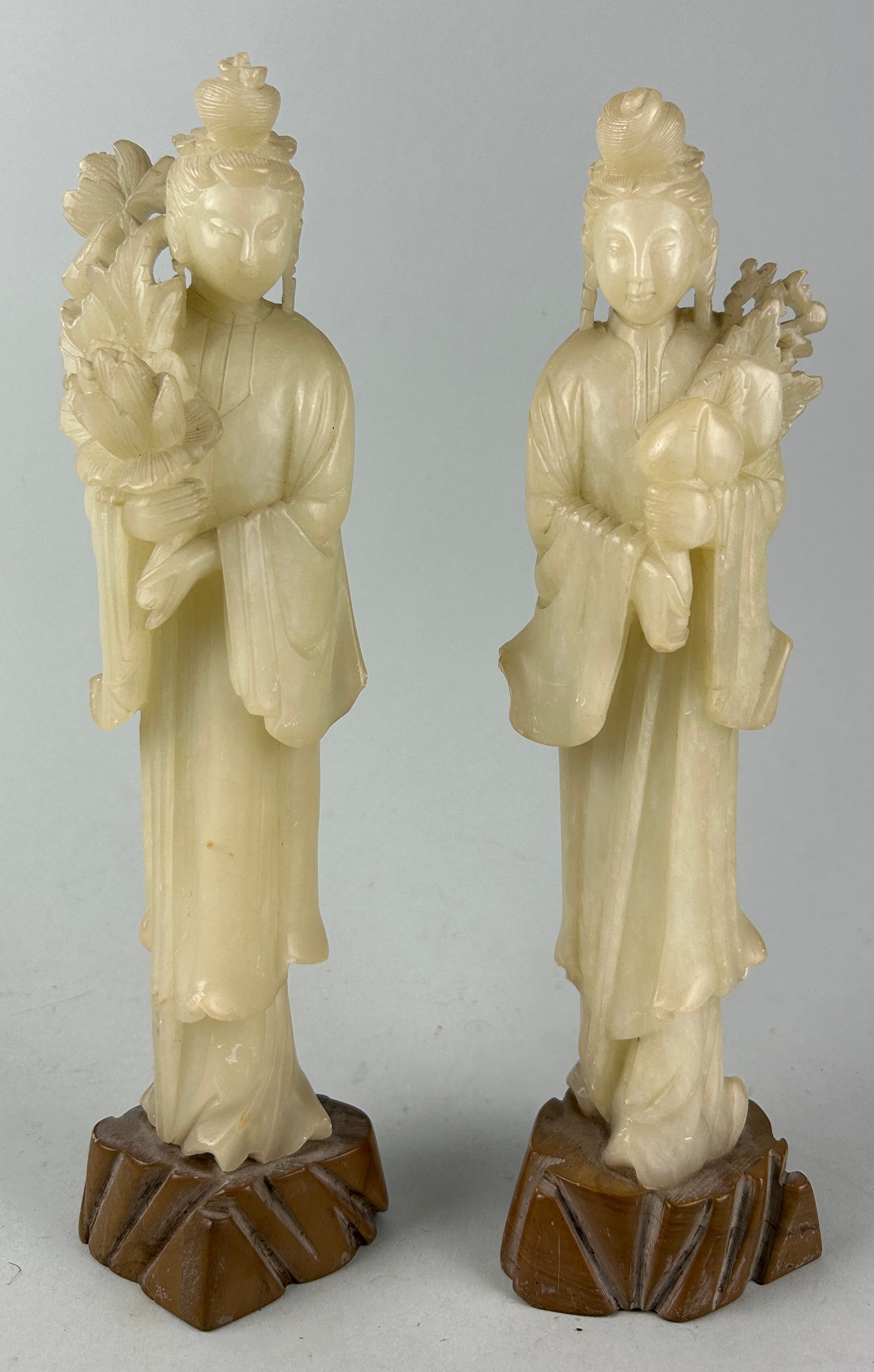 TWO MODERN CARVED JADE CHINESE FIGURES OF WOMEN HOLDING FLOWERS, Marked ‘China’ to verso. 30cm H