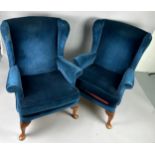 A PAIR OF QUEEN ANNE DESIGN WINGBACK ARMCHAIRS, Upholstered in blue velvet fabric. 96cm x 76cm x