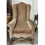 A QUEEN ANNE STYLE WINGBACK ARMCHAIR, Velvet upholstered with heavily carved walnut apron and
