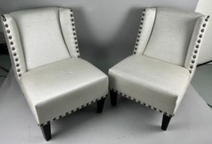 A PAIR OF SIDE CHAIRS UPHOLSTERED IN CONTEMPORARY NEUTRAL STUDDED FABRIC, 85cm H Each raised on four