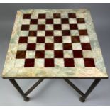 A MARBLE AND ONYX CHESS TABLE, Raised on brass legs supported by a central x frame stretcher (