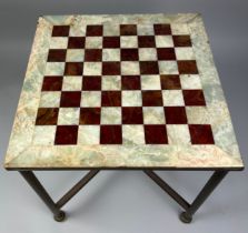 A MARBLE AND ONYX CHESS TABLE, Raised on brass legs supported by a central x frame stretcher (