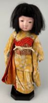 AN EARLY 20TH CENTURY CHINESE DOLL WITH HUMAN HAIR, Dressed in traditional court robes. 45cm x 20cm