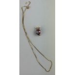 A 9CT GOLD AND AMETHYST HEART SHAPED PENDANT BROOCH With nine small pearls set into a gold crown