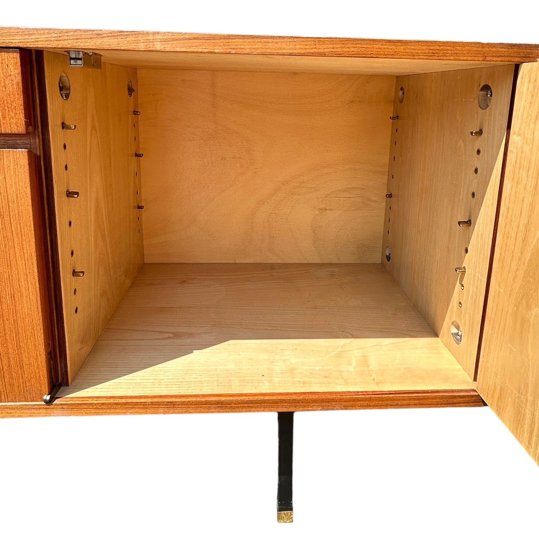 A MID CENTURY TEAK SIDEBOARD, four opening compartments and two central drawers. The compartments - Image 10 of 10
