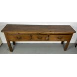 A 19TH CENTURY ELM DRESSER BASE, The plank top with three sliding drawers, raised on four straight