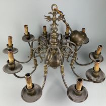 A LARGE BRASS TEN ARM CHANDELIER WITH EAGLE SHACKLE,